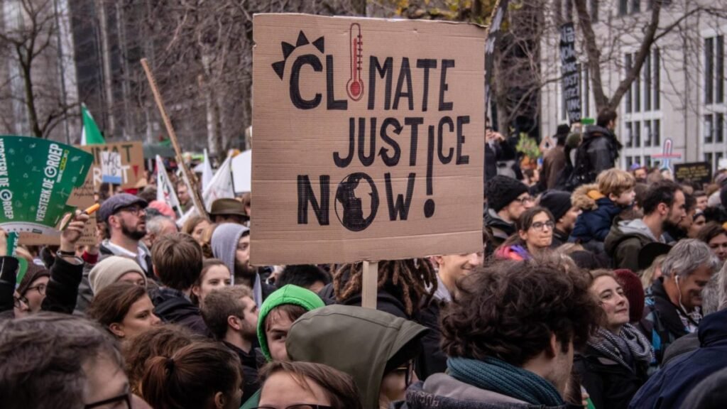 A climate justice activist from the global south demanding action at a protest.