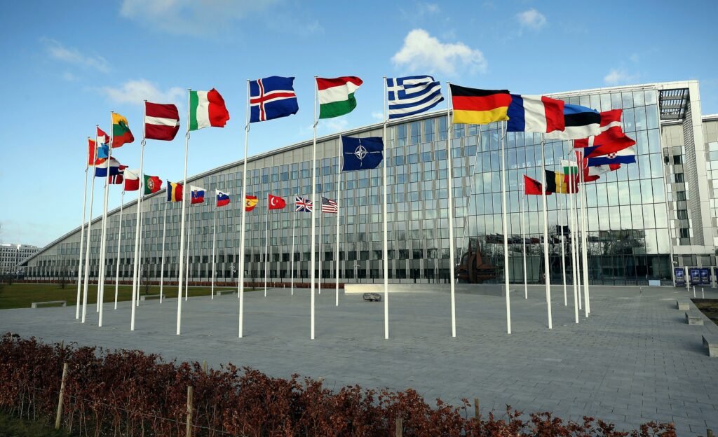 An organizational flowchart showing the North Atlantic Council (Political) directing the Military Committee, which commands Allied Command Operations (SHAPE) for missions and Allied Command Transformation for future capabilities.